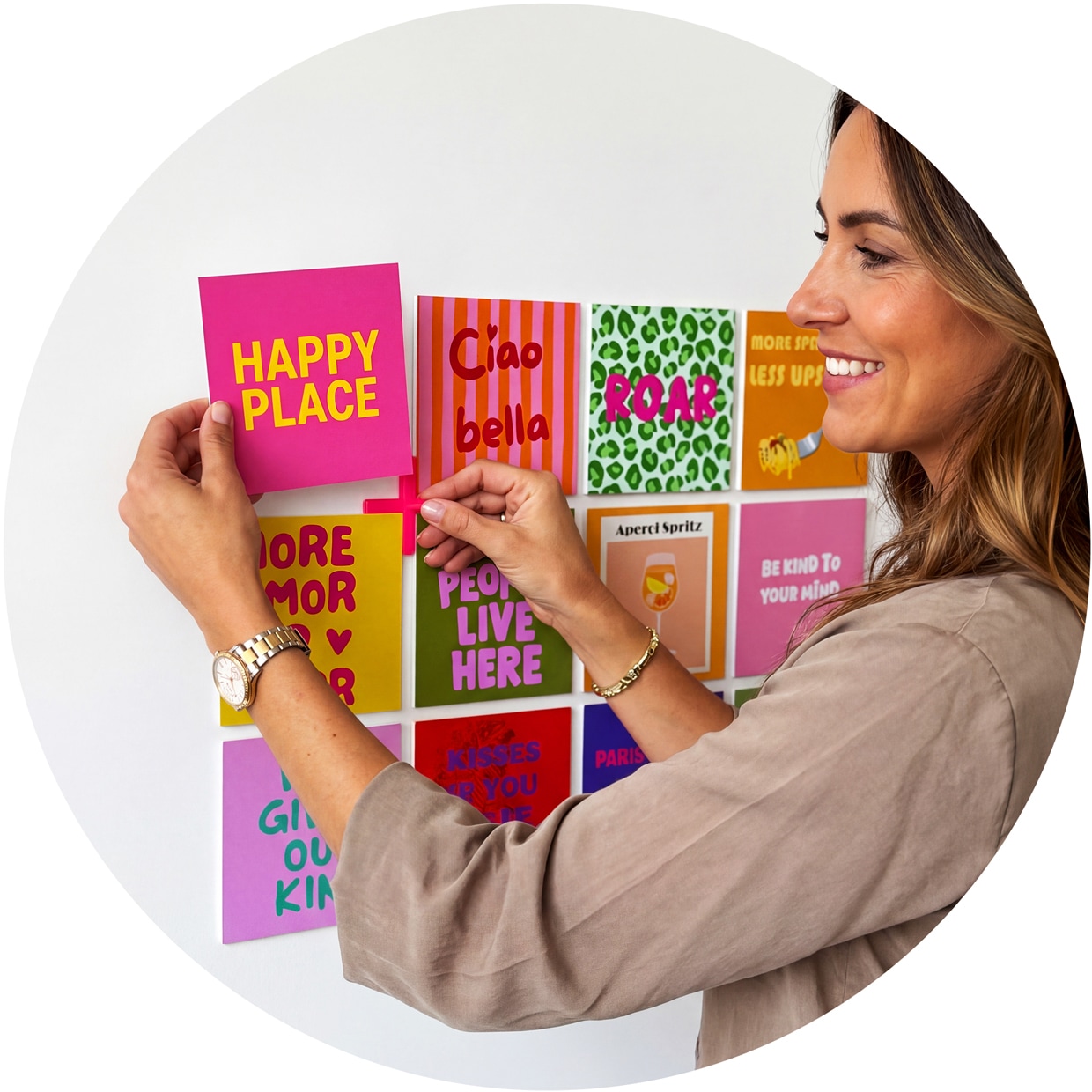 A woman adding a Happy shape to her wall next to other Happy shapes.